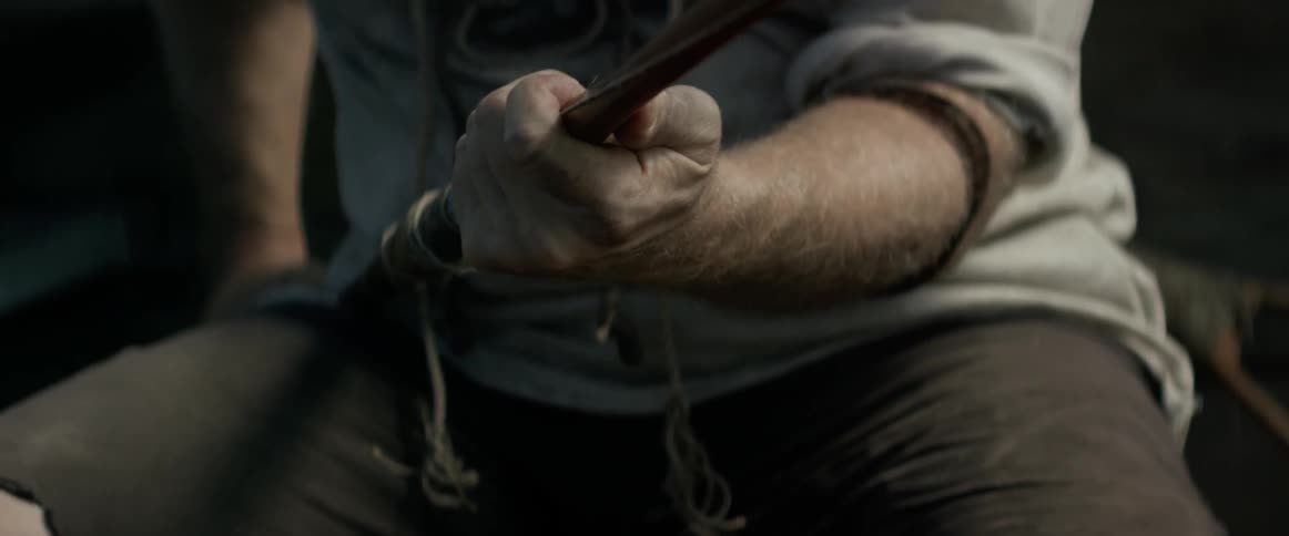 A man is holding a makeshift fishing pole