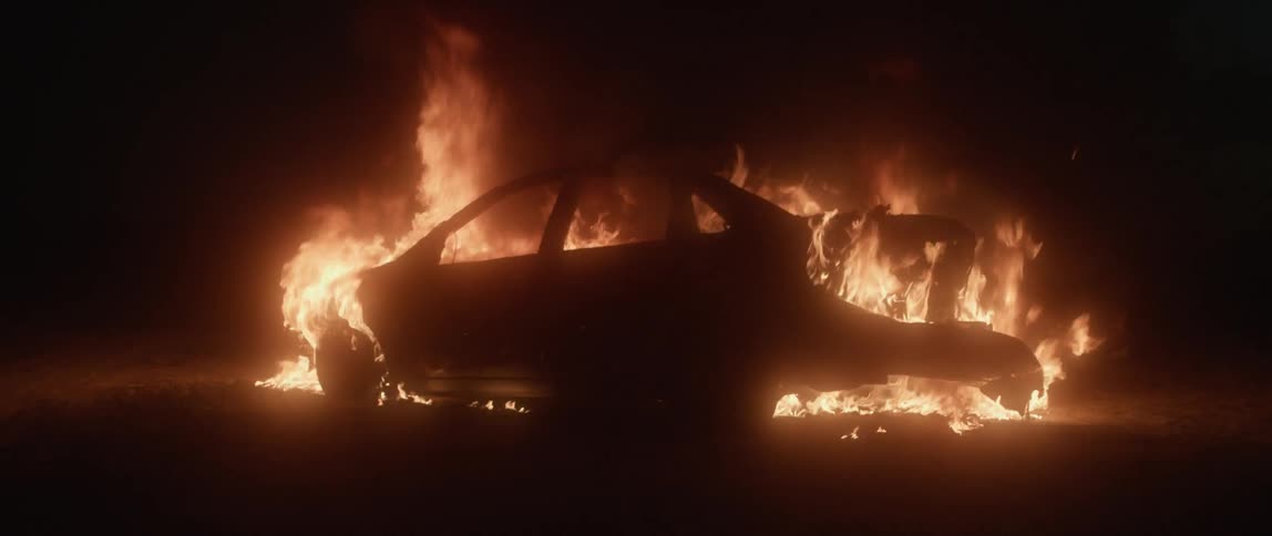 Car blazing on fire at night