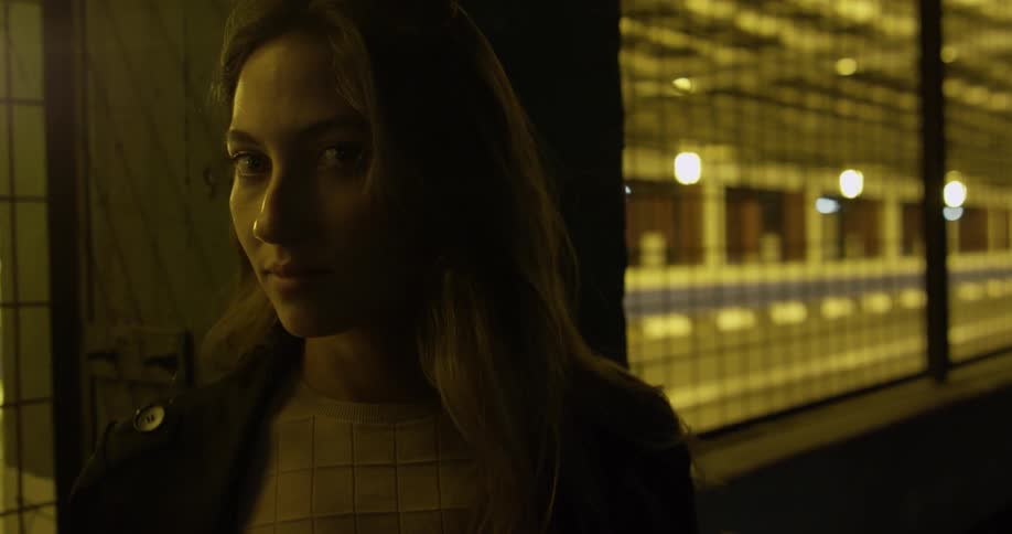 A woman is standing in a subway tunnel