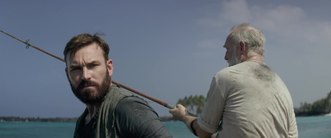 Two men fishing into a sea on a clear day
