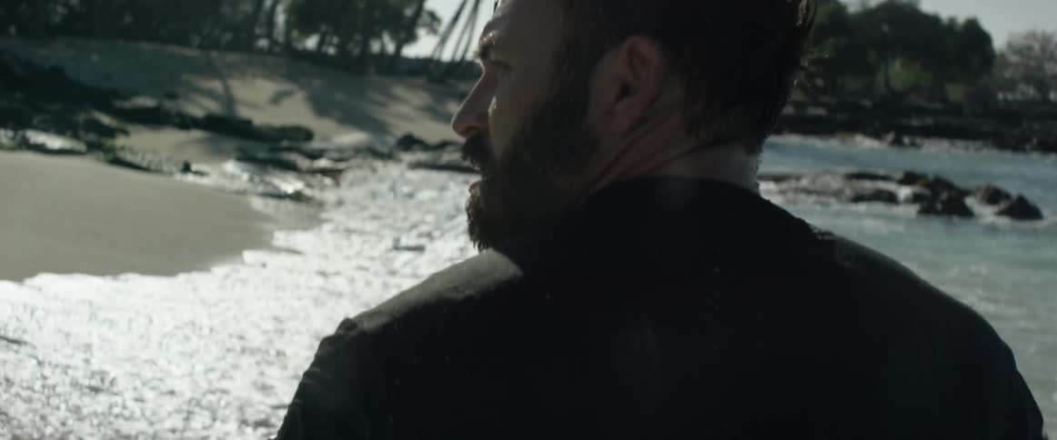 A man walks along the shore