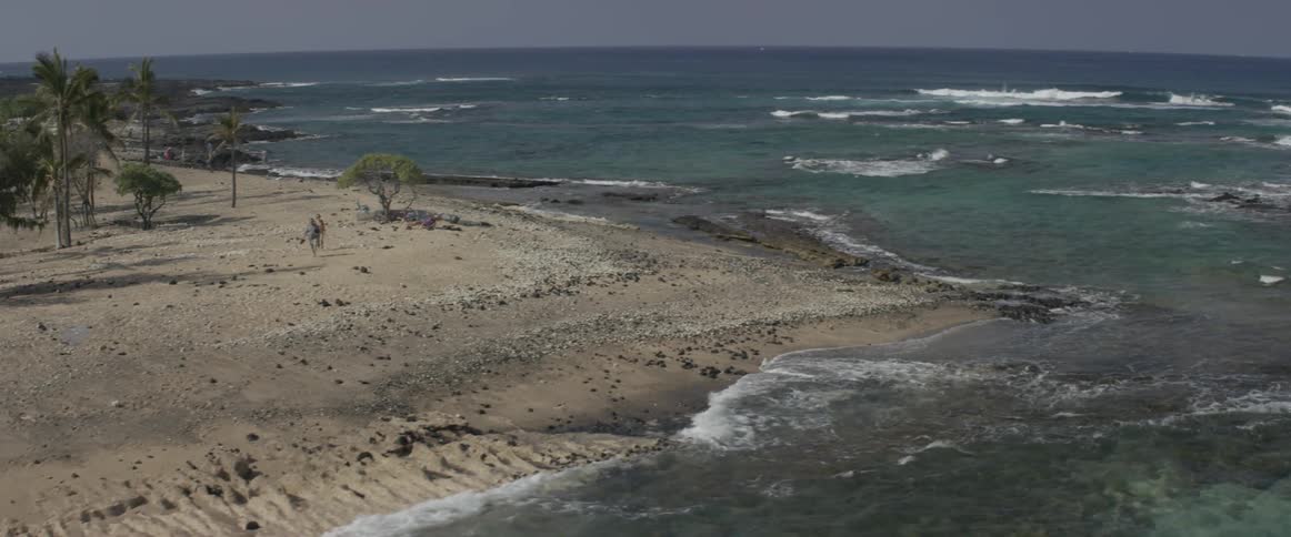Aerial view of a shoreline with calm waters coming ashore