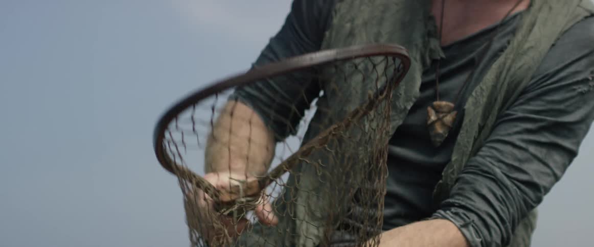 A man is holding his fishing net.,
