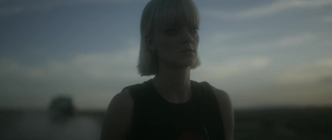 A woman is hiking outside at dawn