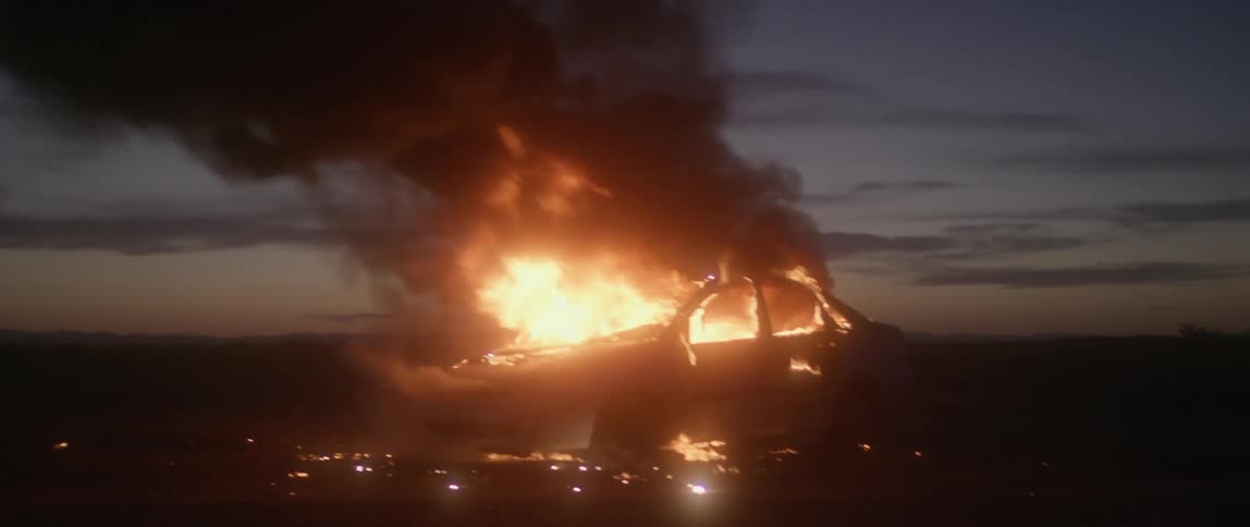 A car is on fire at dawn