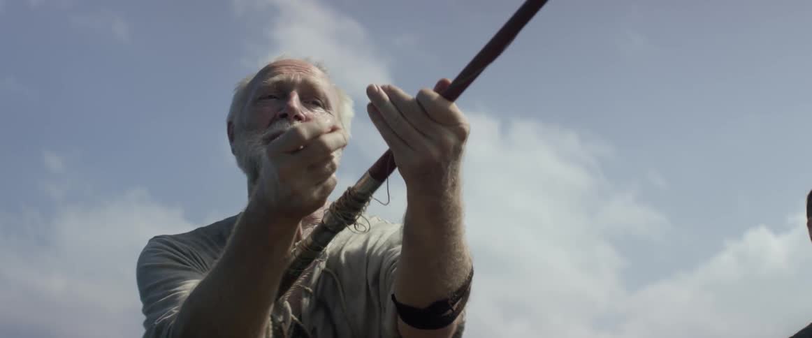 A man is fishing on a windy day
