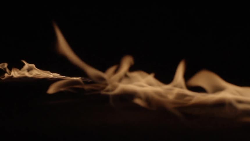 Flames on the ground in the dark