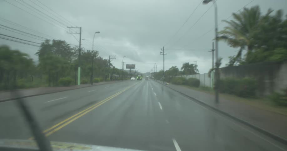 Cars drive on the road in the rain