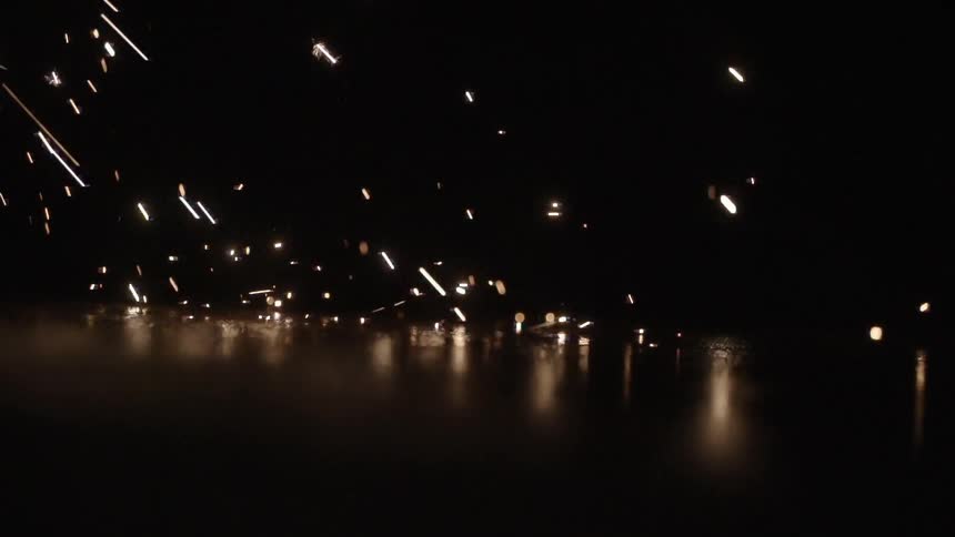 Sparks falling onto floor with a black background