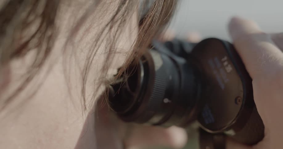 A woman is looking through binoculars