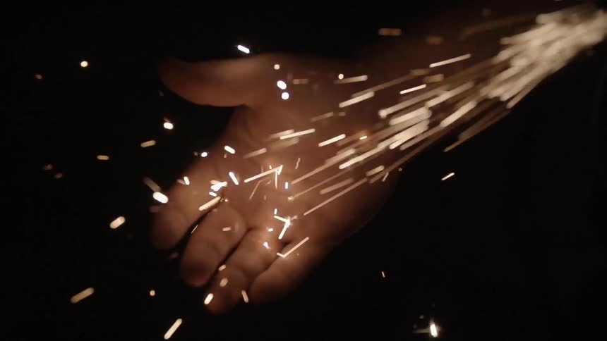 Hand held out with sparks hitting it