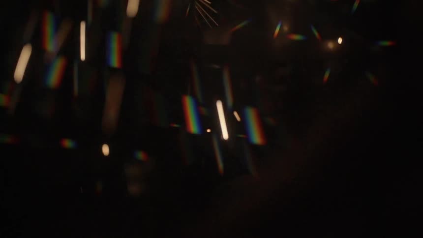 Sparks of light shining over black background
