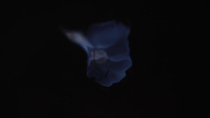 A shapeless structure wavers in the dark background