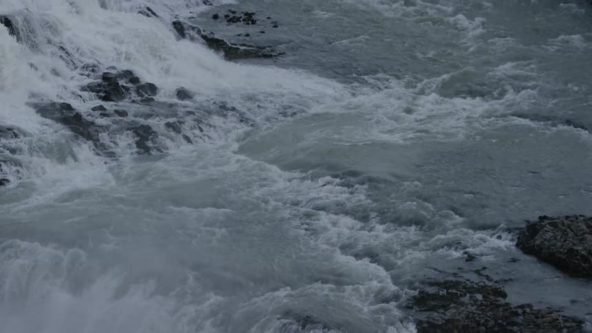 Water cascades over a waterfall