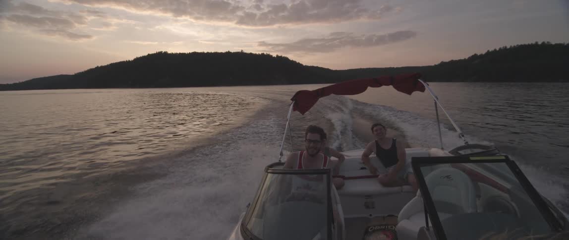 People enjoy a boat ride at sunset