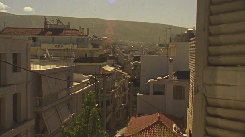 View of buildings in city outside window of apartment during the day
