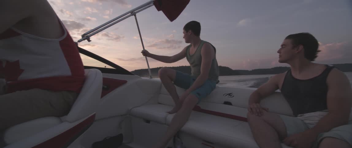 People sitting on a traveling boat on a cloudy day