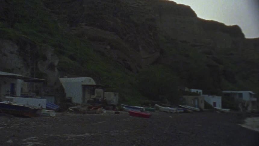 Buildings and boats sit on a lakeshore