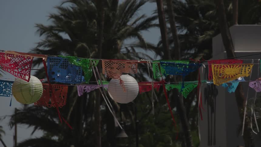 The wind blows the flags on the lines
