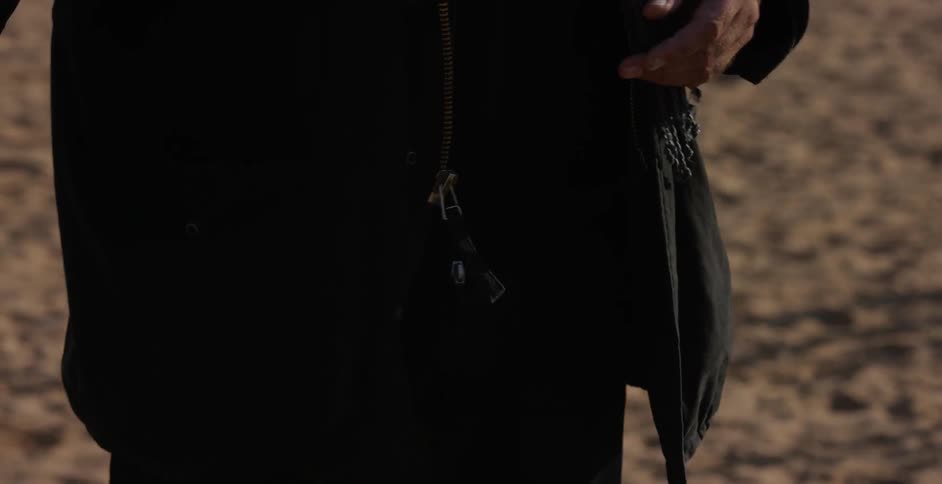 A man flips around an item in his hand