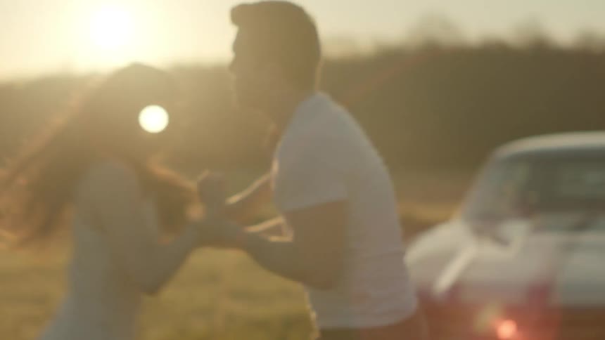 Man in a white t shirt argues with a woman with long hair