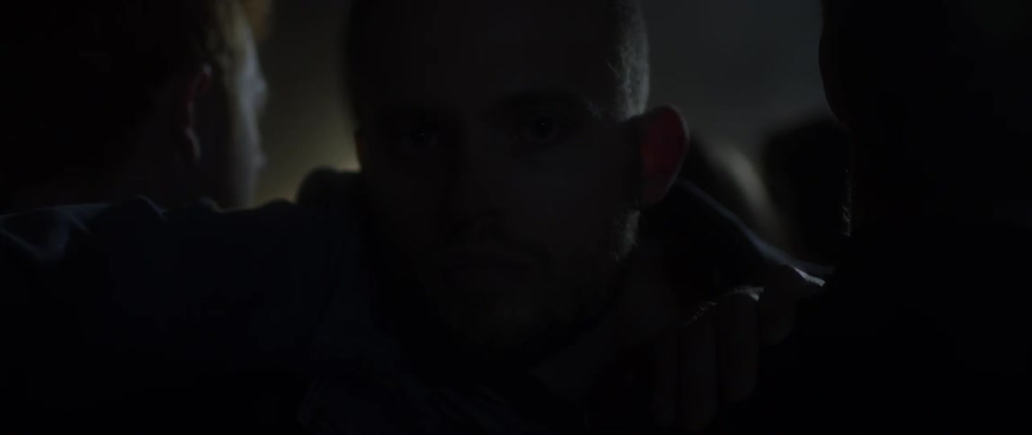 A man stands in a crowd in a club