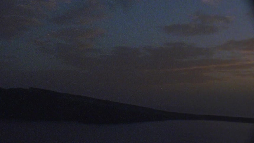 The dawn sky gets dark towards the shore