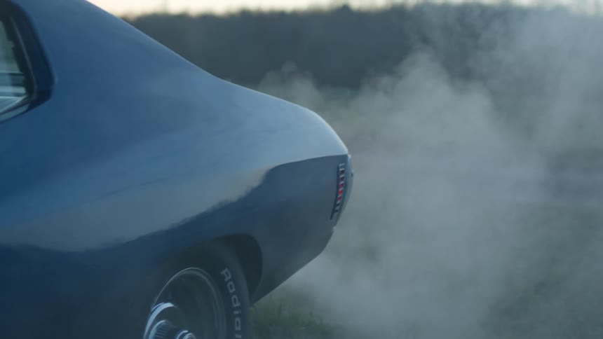 Exhaust pours out of the back of a sports car