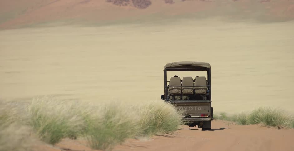 A truck drives into the desert