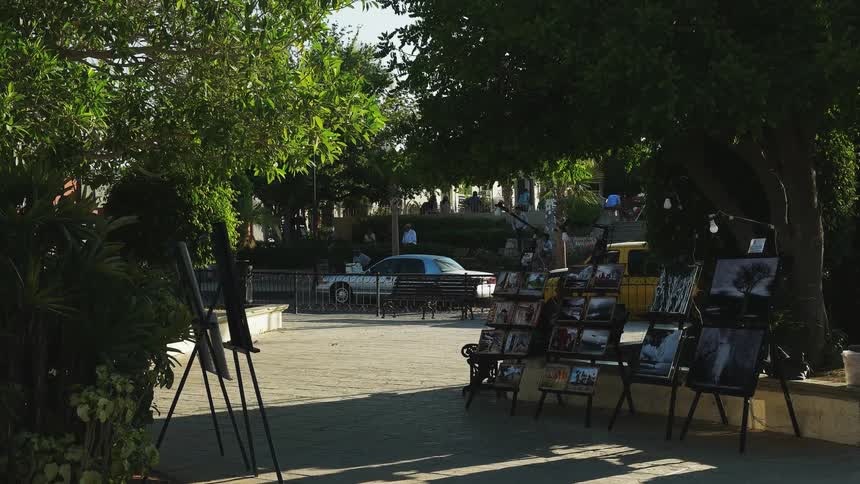 An art street vendor storefront is set on the sidewalk