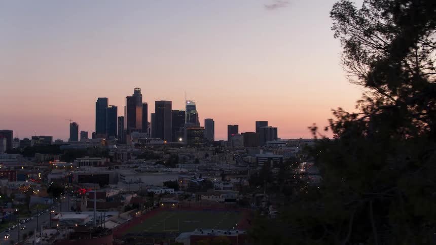 Skyscrapers and buildings in city after sunset