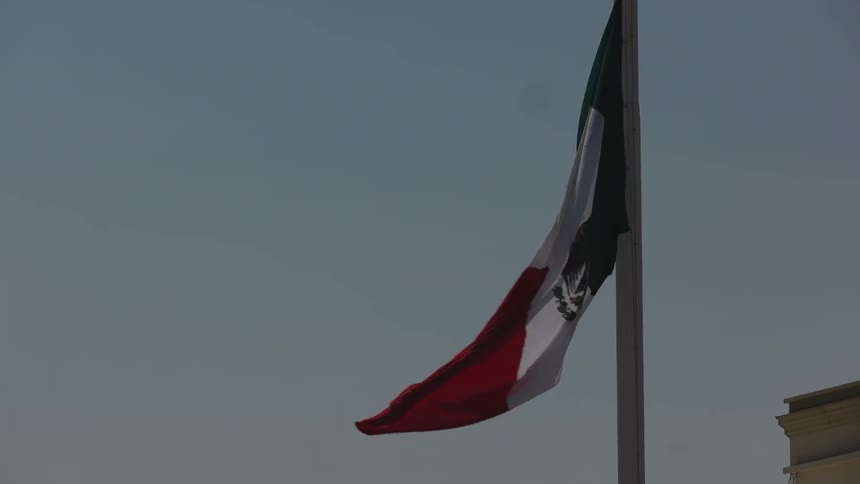 A mexican flag waves in the breeze