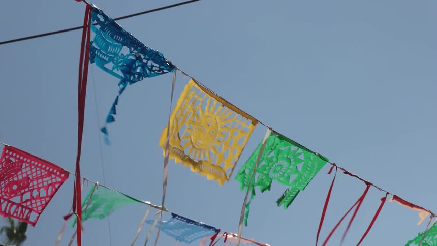 Colored flags and streamers hang from a wire