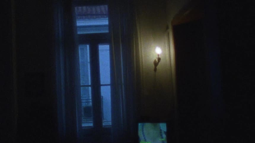 The hallway leading to the door is dark