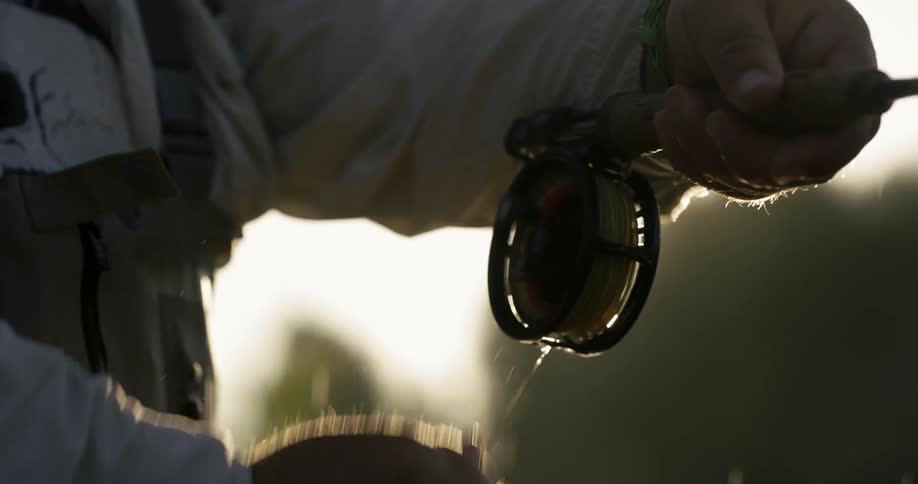 A fisherman reels in his line