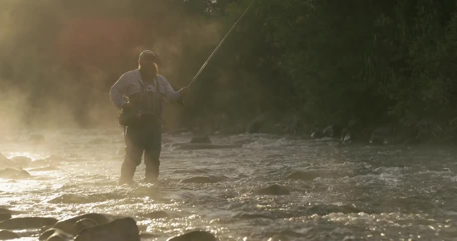 A man fishes in a stream