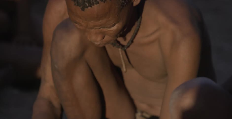 A man leans over to work on something