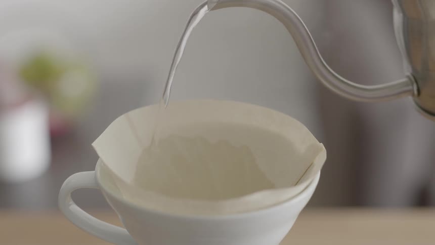 Water being poured from a kettle into a cup