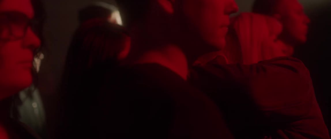 A man walks through a group of people in a dance hall