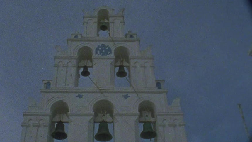 Bells are hanging in the archways of a bell tower