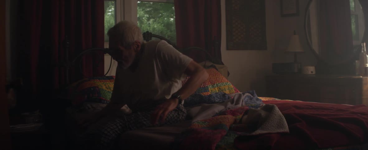 A man gets up from bed