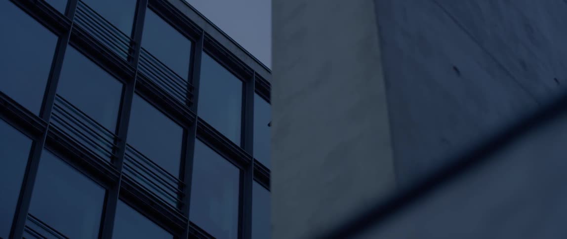 A camera sits mounted on the side of a building