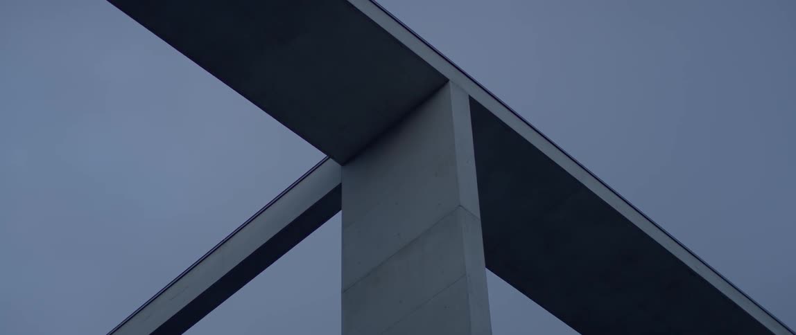 Concrete beams hang above