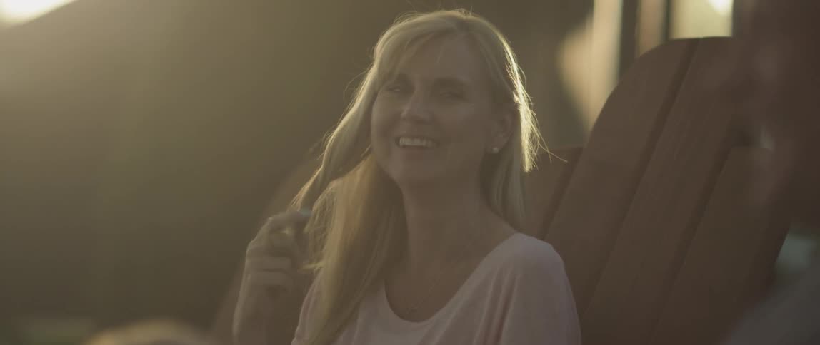 A woman is twirling her hair as she talks