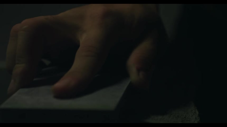 A man wipes a wet stone
