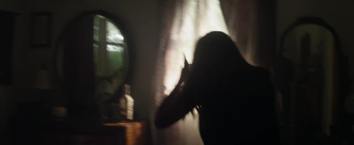 A woman is walking through the house in a panic and finds her father on the floor