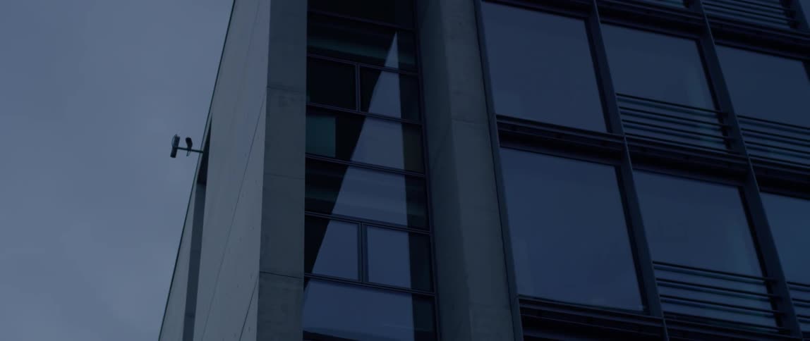 A security camera is on the corner of a building