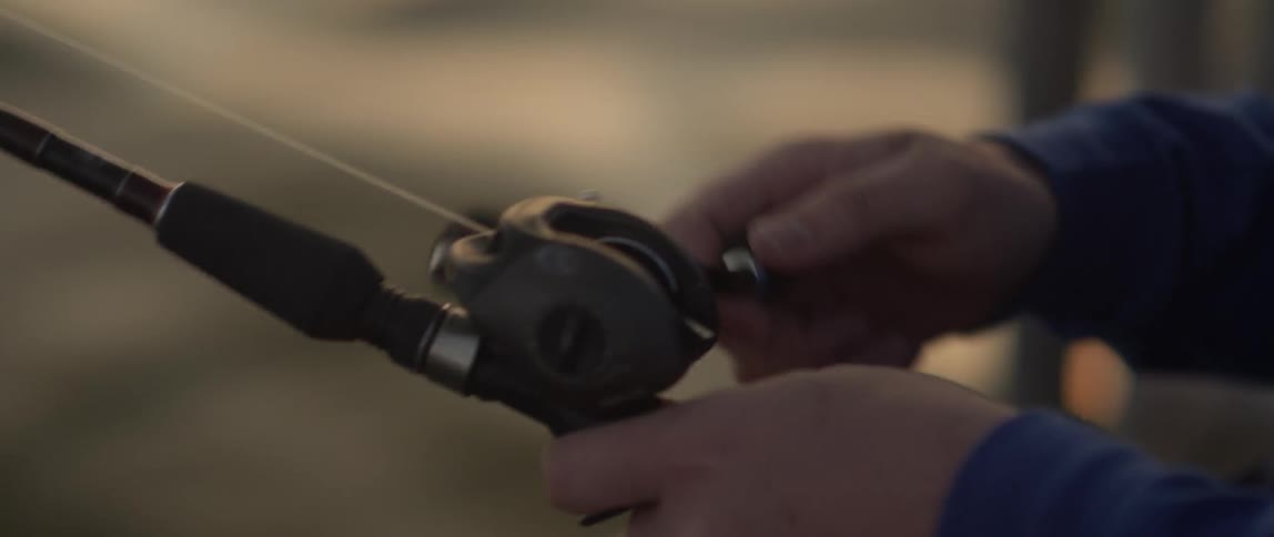 A man reels in a fishing rod
