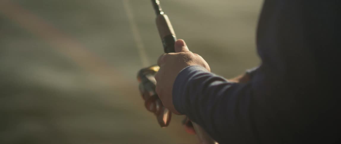 A person is fishing on a sunny day