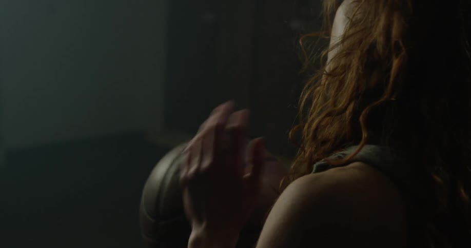 A woman holds and spins a basketball